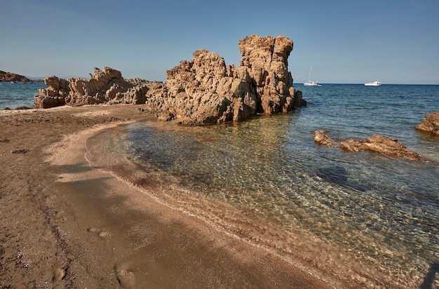 Deserted rocky small beach of southern Sardinia during an August summer afternoon
