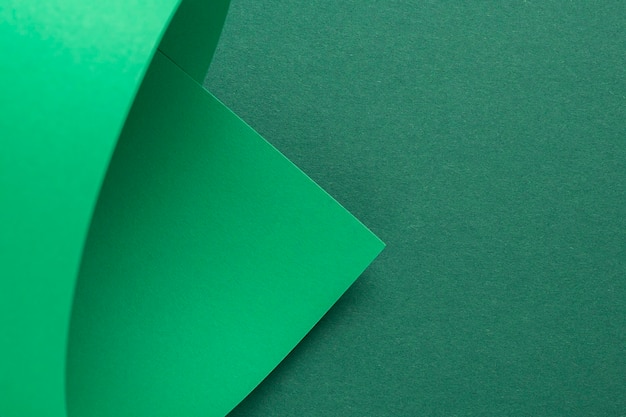 Design background curved background from green cardboard. Top view, flat lay.