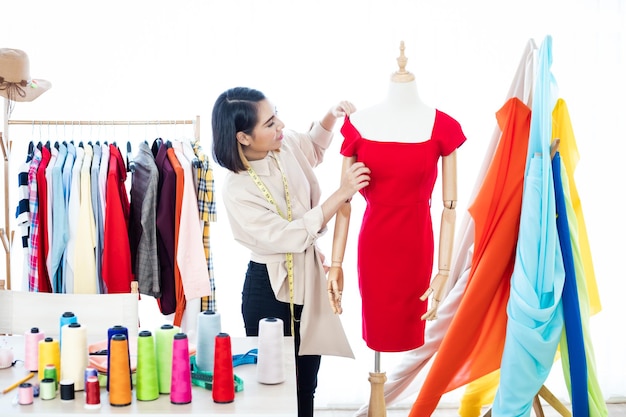 Designers are checking the details of the clothes after they are sewn in the studio.