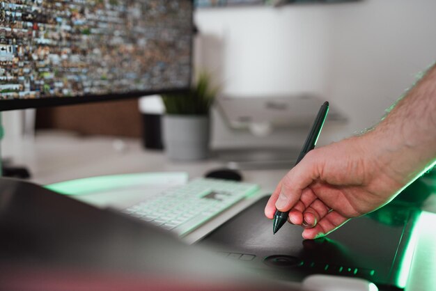 Designers hand holding a graphics tablet pen