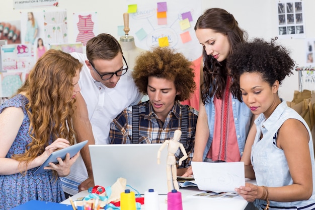 Designers using laptop and digital tablet