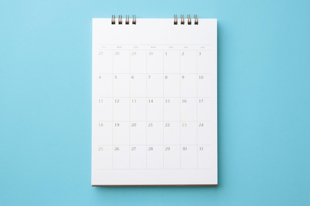 Desk calendar on blue background business planning appointment meeting concept