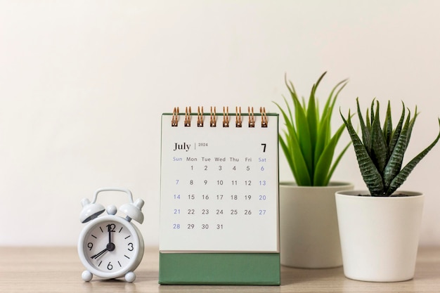 Desk calendar for July 2024 on the table with copy space