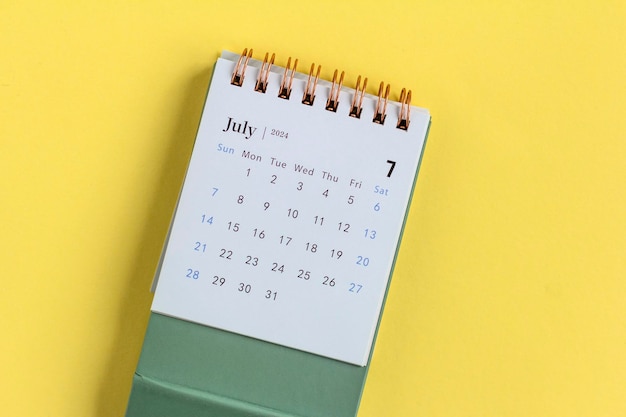 Desk calendar for July 2024 on a yellow background