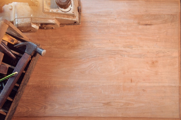 Desk of a carpenter with different tools. Studio shot on a wooden background,vintage style