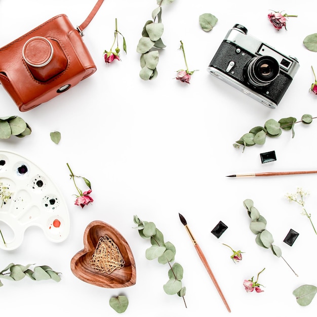 Desk retro camera watercolor brushes leaves eucalyptus on white background