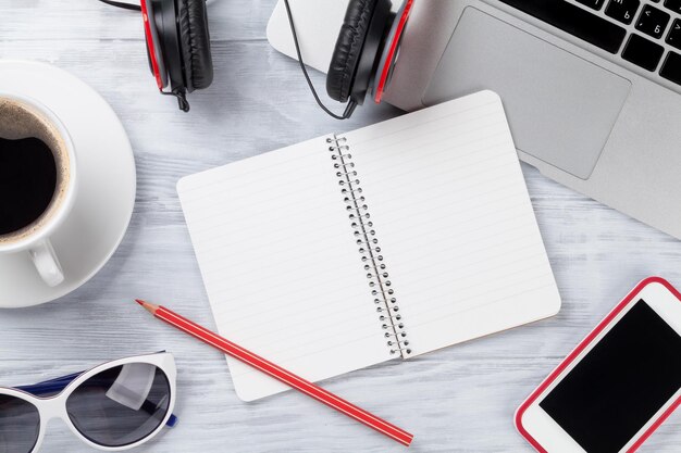 Desk table with laptop coffee and notepad