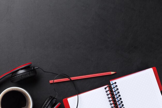 Desk with notepad coffee and headphones