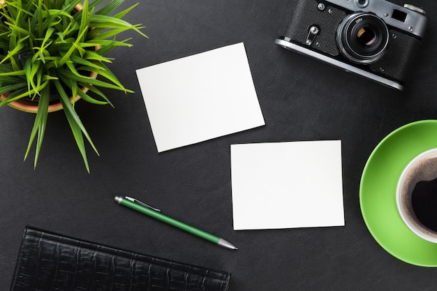 Desk with photos camera supplies coffee and flower