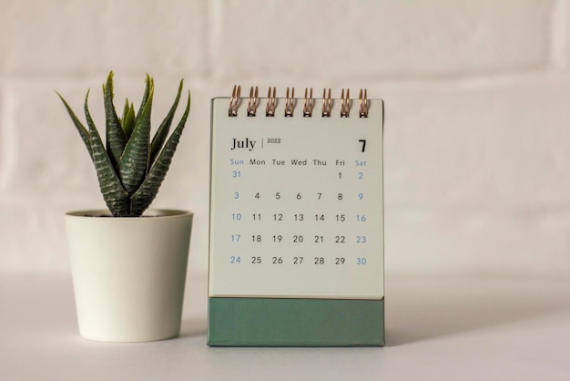 Desktop calendar for July 2022 on the table