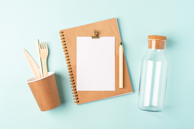 Desktop planner. Flat lay of blue mint table  . Top view glass jar, coffee cup