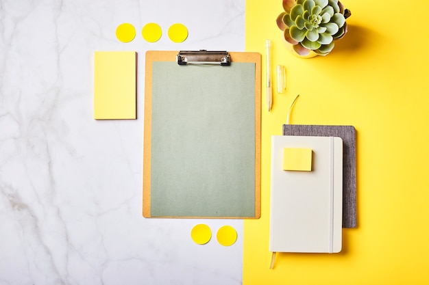 Desktop with clipboard mockup and office supplies. Home office, planning goal setting concept. Flatlay, top view