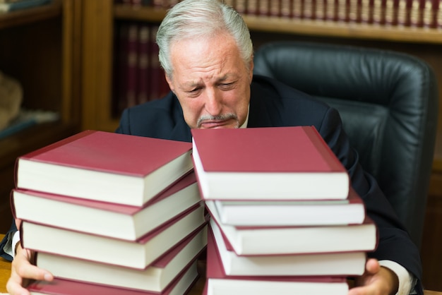 desperate man surrounded by books