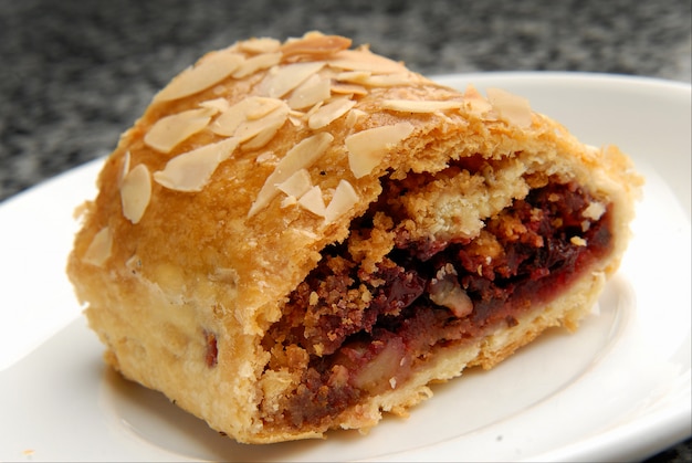 Dessert cake with fresh cherries and jam nuts on a plate