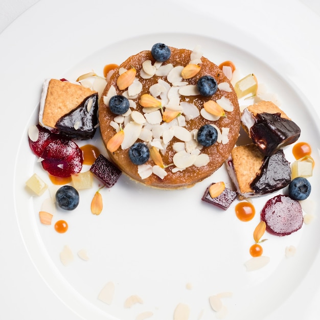 Dessert pastries and confectionery assortment on white background. delicious restaurant food. overeating problems.