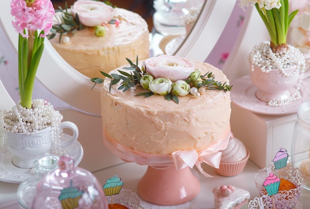 Dessert Table at Wedding Reception Beautiful wedding cake with flowers on table