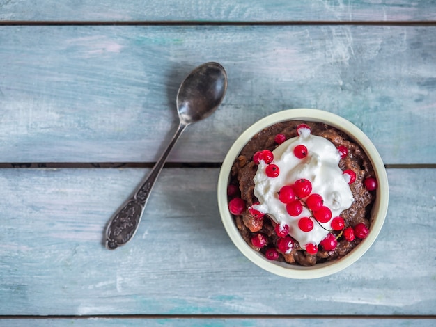 Dessert of their rye bread with whipped cream and red currant berries