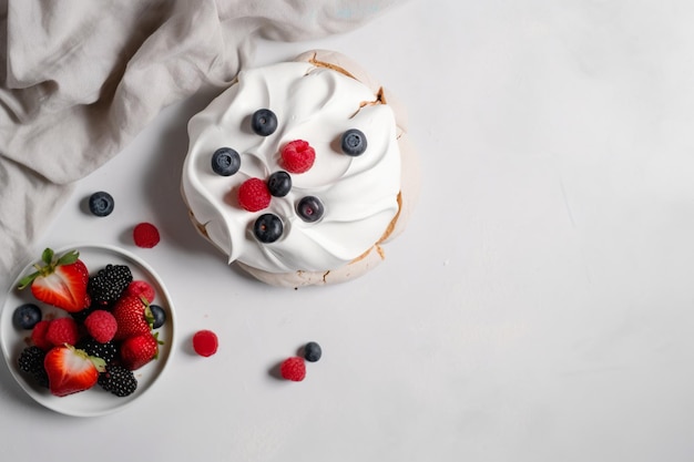 A dessert with a bowl of fresh berries on the table