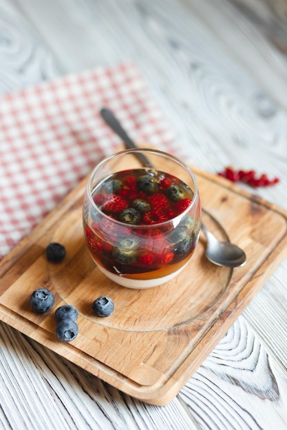 Dessert with fruits, jelly and panna cotta on a light background