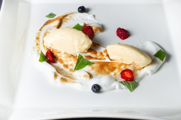 Dessert with whipped cream strawberries and raspberries Clouseup