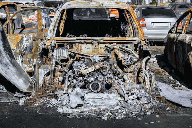 Destroyed engine and under the hood space of burned car Arson of a vehicle Insurance case