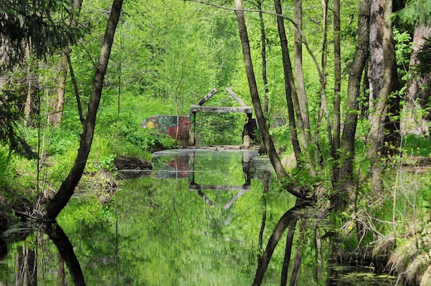 Destroyed hydraulic structure on a small river on a Sunny day Moscow region Russia