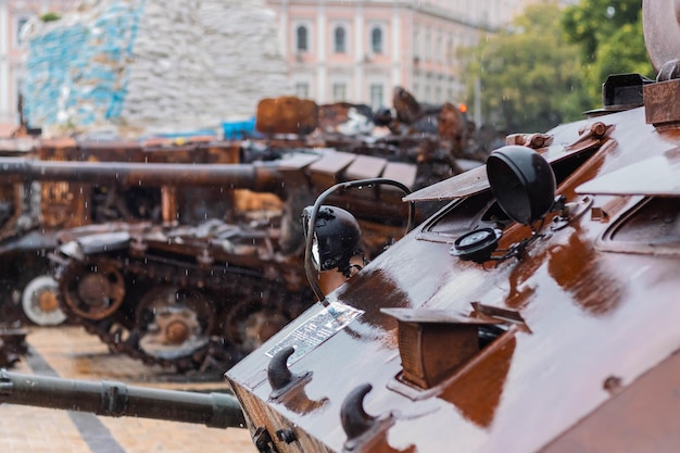 Destroyed Russian tank in the rain Rusty broken military equipment in the rain