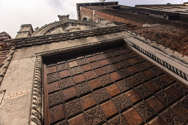 Detail of building with window and details and architecture in Venice in Italy