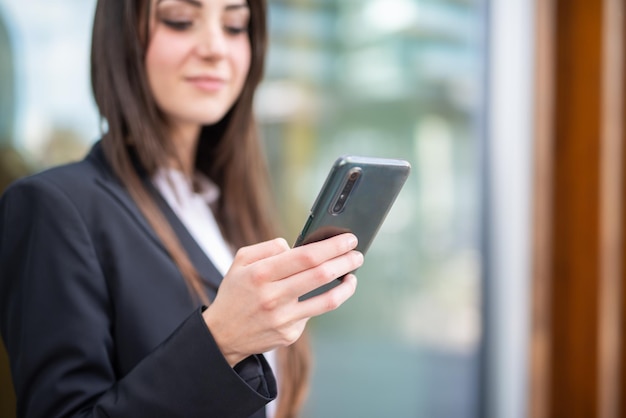 Detail of a business woman using her smartphone