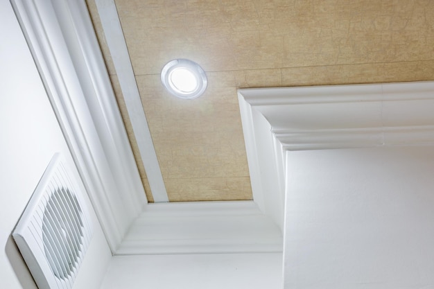 Detail of corner ceiling with intricate crown molding Suspended ceiling and drywall construction in empty room in apartment or house Stretch ceiling white and complex shape