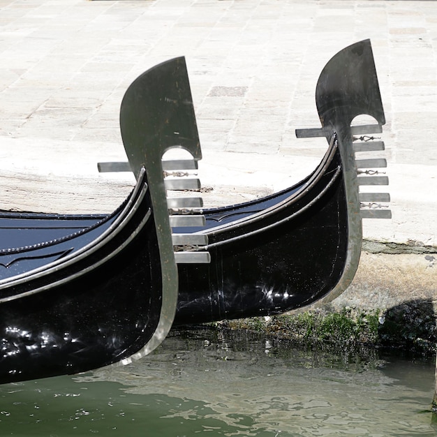 Detail of the distinctive prows of two Venetian gondolas