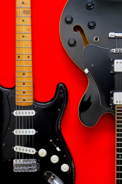 Detail of Electric Guitar on a red surface