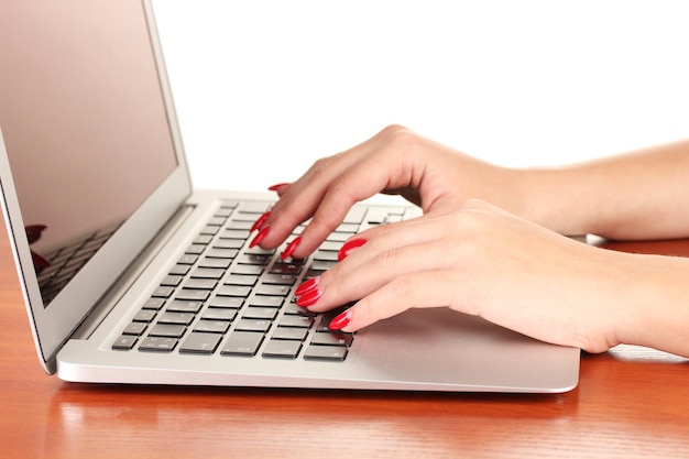 Detail of female hands using computer isolated on white