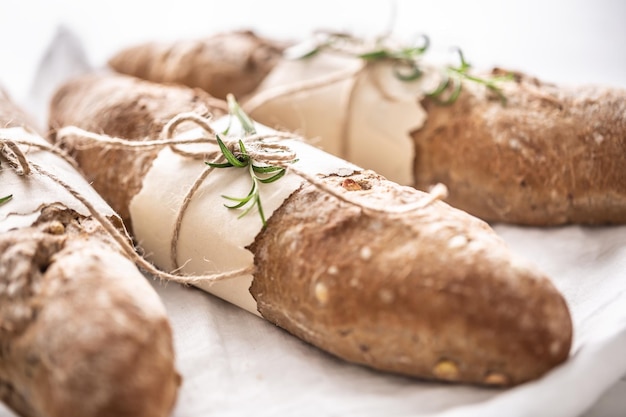 Detail of fresh crusty wholegrain breads on a white surface