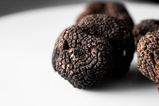 Detail of a freshly picked organic black truffle ready to serve in a restaurant Tuber nigrum