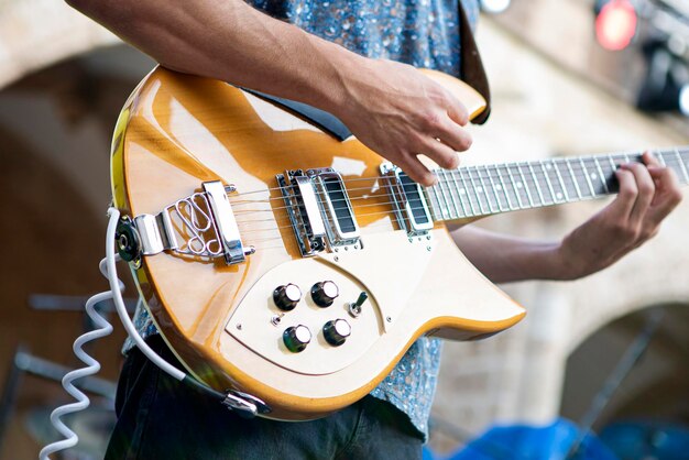 Detail of hand on electric guitar in music concert