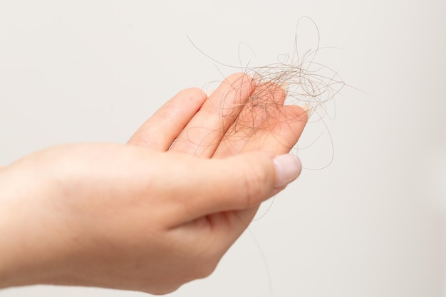 Detail of a hand of woman with fallen hair