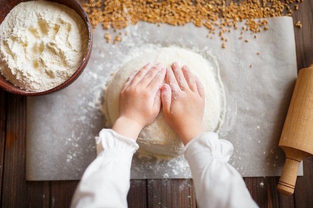 Detail of hands kneading dough