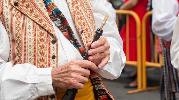 Detail of the hands of a musician with a traditional Valencian wind instrument