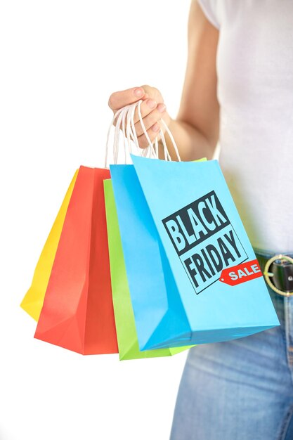 Detail of the hands of an unrecognizable young woman holding colorful bags on a white background shopping concept sales black friday christmas