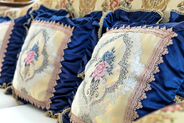 Detail image of pillows on an antique luxury sofa