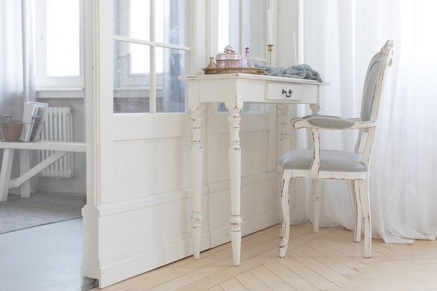 Detail of the interior of the room with the female boudoir. Interior with wooden table and different cosmetics at home.