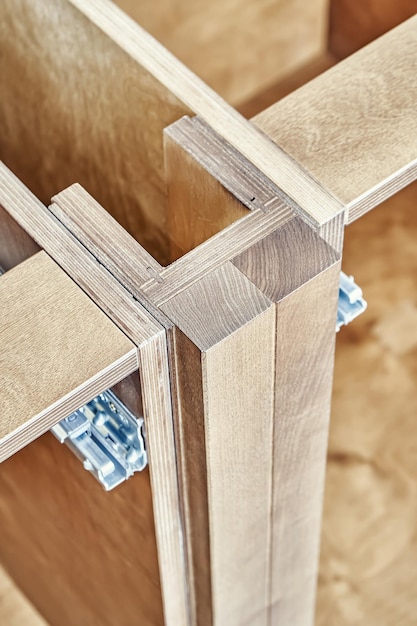 Detail of kitchen furniture made of plywood and solid ash wood installed brick wall close view