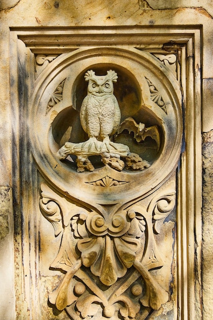 Detail of owl and bat limestone sculpture in Central Park New York City