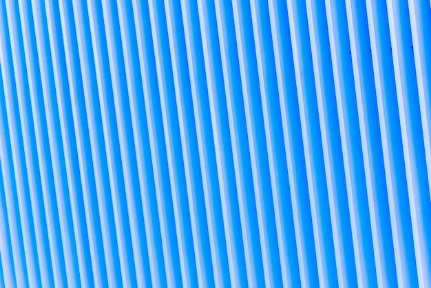 Detail of pattern striped metal facade for blue background