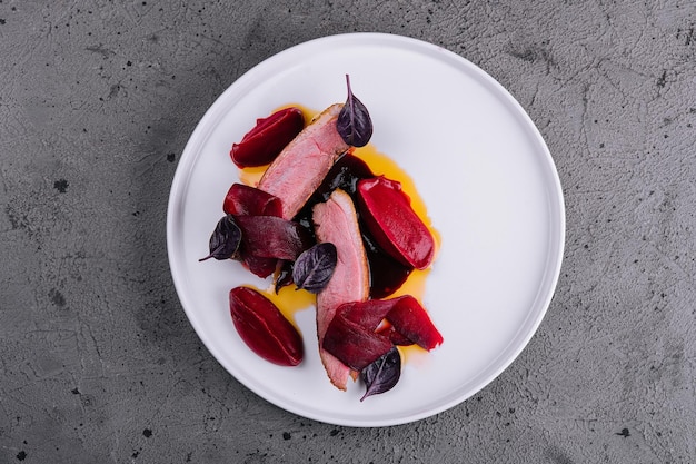 Detail of pork tenderloin prepared on a white plate