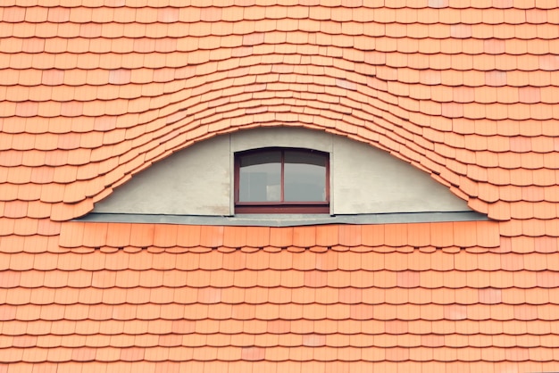 Detail red tiled roof with window