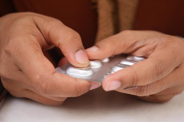 Photo detail shot of women holding blister packs