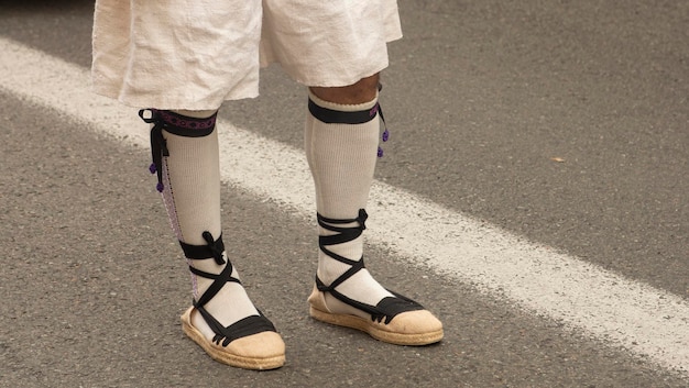 Detail of the slippers of a man dressed in the traditional Valencian costume