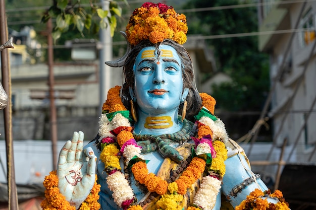 Detail of the statue of Shiva, hindu idol on the ghat near the Ganges river in Rishikesh, India, close up